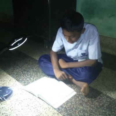 Inmate Using The Solar Table Lamp To Study