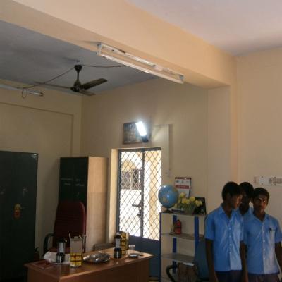 Students Below Solar Lamp In School Office