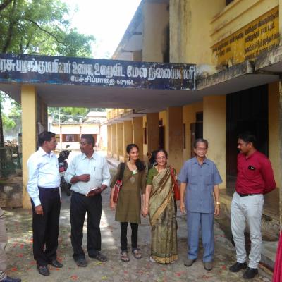 Hm Teacher With Guests In Front Of The School