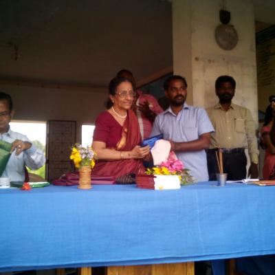 Mrs Partha Sarathy Presnting A Book To The Teacher