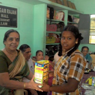 Mrs. Ramalakshmi Subramanian Wife Of S.g.subramanian Trustee Dpf Presenting The Solar Lantern