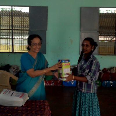 Smt. Nalini Partha Sarathy Handing Over The Solar Lantern
